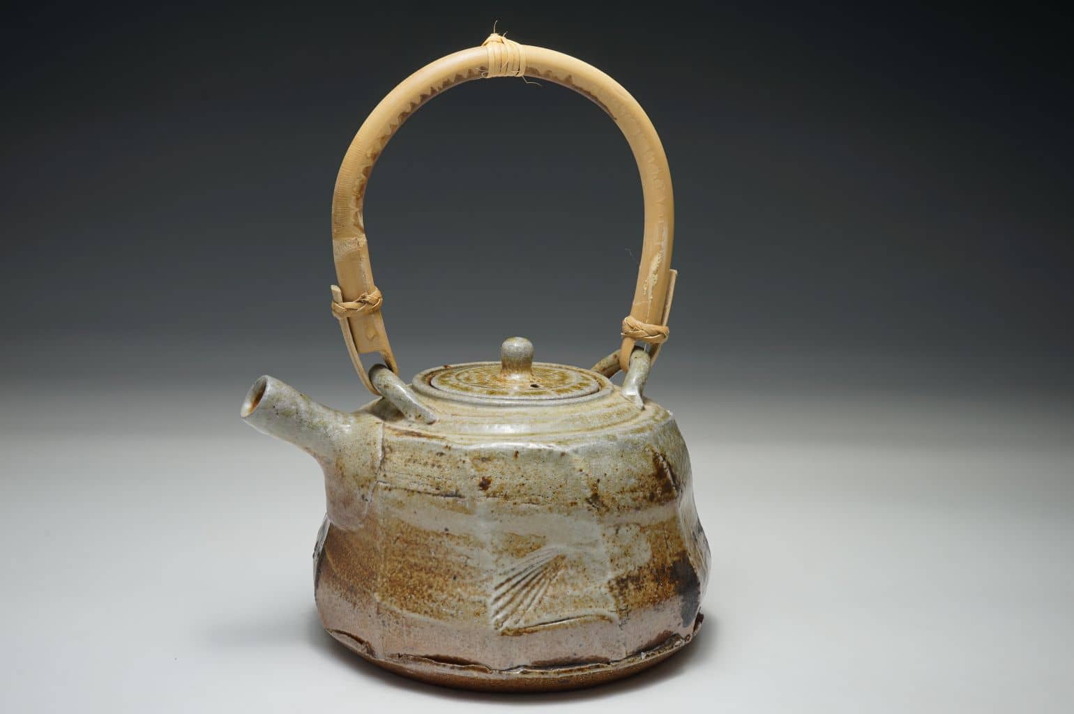 Wood salt fired teapot, cut sided surface. Heavy salt-glazed surface with sea shell indentation.