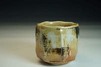 Wood-fired Chawan tea bowl. Sculptured surface with Shino glaze and salt.
