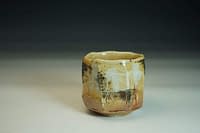 Wood-fired Chawan tea bowl. Sculptured surface with Shino glaze and salt.