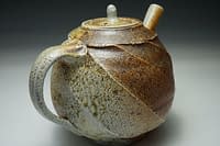 Wood salt fired teapot with cut sided and heavy salt glazed surface.