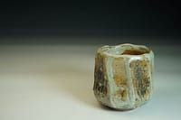 Beautiful wood-fired chawan tea bowl in stoneware, with a shino glaze. Interesting outer surface wood fired with salt.